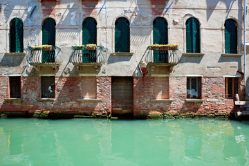 Fassade of old venetian house standing in water