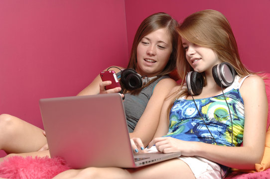 Teens using mobile phone and computer