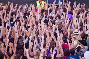 crowd holding up hands