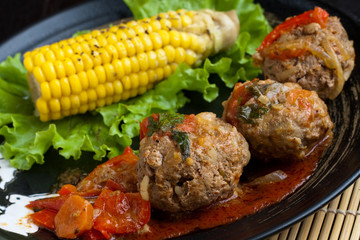 Meetballs served with corn and lettuce