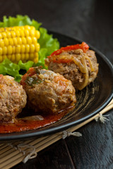 Meetballs served with corn and lettuce