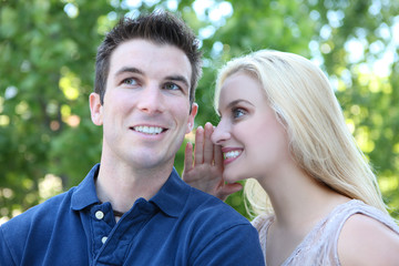 Fototapeta premium Attractive Couple Secret (Focus on Woman)
