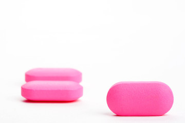closeup of three pink pills