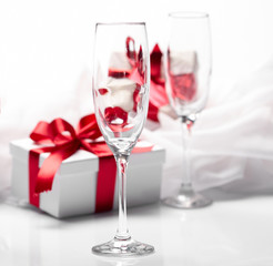 Gift decorated with bow, glass wine