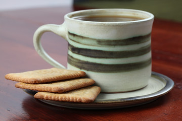 Biscuits and coffee. Focus on biscuits