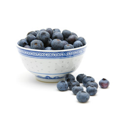 fresh ripe blueberries in a small blue bowl