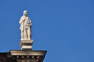 Fototapeta na wymiar Statue on top of church