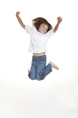 A young girl jumps up in the air in this studio image.