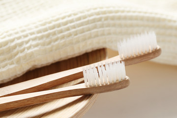 Fototapeta na wymiar Closeup of wooden toothbrush with towel