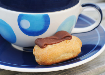 Mini chocolate choux pastry with blue decorated cup
