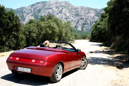 Man in cabriolet on vacation in Corsica, France