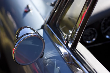 Classic rear mirror on blue car