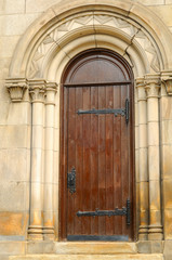 Narrow doorway in an old stone church