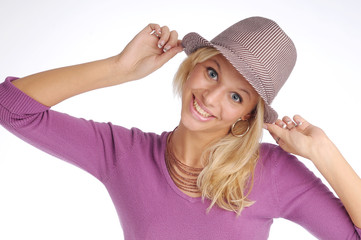 Atractive blonde woman with hat in violet sweater