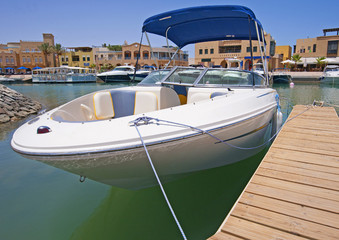 Luxury speedboat moored to a jetty