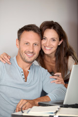 Couple at home surfing on internet