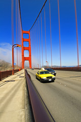 Yellow taxi crossing the Golden Gate Bridge