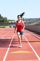 Fototapeta premium Young hispanic teen girl running on track
