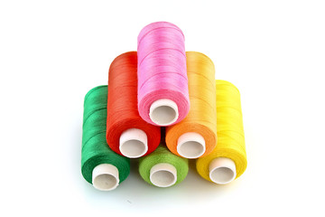 Few bobbins isolated on white