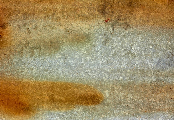 Zinc metal surface with rusty stains.