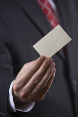 Businessman holding business card - Finance