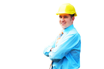 Young architect wearing a protective helmet standing on the buil