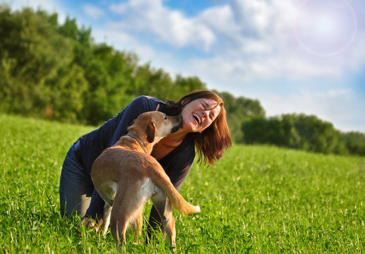 girl and dog playing around