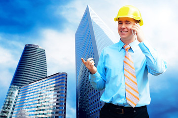 Young architect wearing a protective helmet standing on the buil