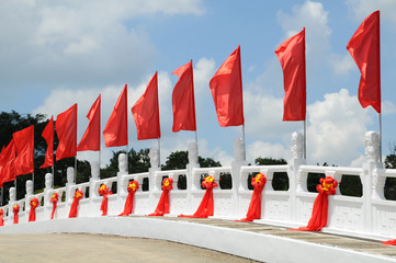 Red Flags Decorating A Bridge