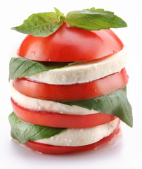 Lined with layers of cross-sections of tomato and mozzarella wit