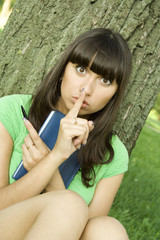 Female in a park with a notebook