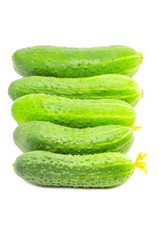 row of fresh cucumbers isolated over white
