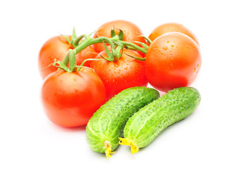 branch of tomatoes and cucumbers isolated over white