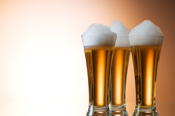 Beer glasses against the colorful gradient background