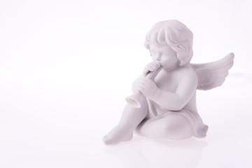 Porcelain angel playing trumpet