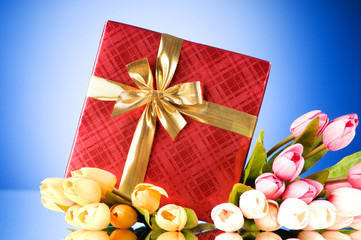 Celebration concept - gift box and tulip flowers