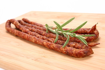 Smoked sausages on a wooden background