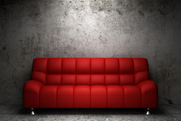 red leather sofa in front of grunge concrete wall