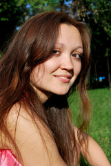 Naklejka premium The young girl in the park