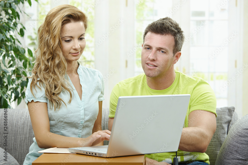 Wall mural couple using laptop computer