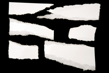 Six pieces of ripped torn white paper on black background