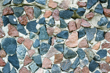 Red and blue stone wall