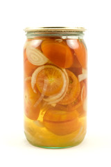 clear glass jar of pickled tomatoes on white background