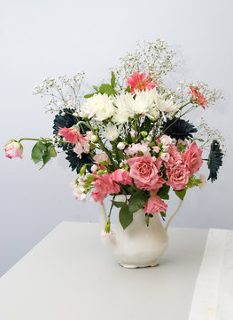 Bouquet of beautiful flowers arranged in a porcelain vase.