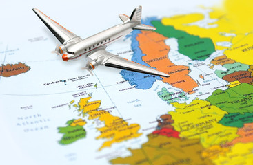 Fototapeta na wymiar Fly from Europe - airplane at the background of the Europe map
