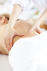 Fototapeta na wymiar Close-up of a caucasian woman receiving a back massage