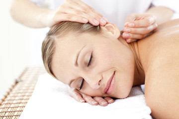 Relaxed woman receiving an acupuncture treatment - obrazy, fototapety, plakaty