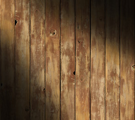 Distressed wooden surface diagonally lit