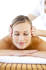 Obraz na płótnie Canvas Radiant young woman receiving a head massage