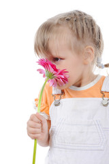 girl sniffs a flower.